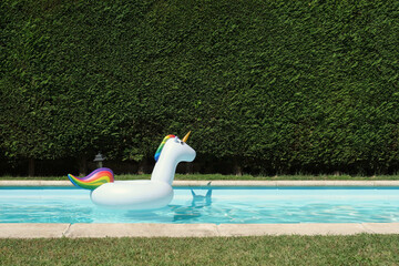 Big unicorn inflatable ring in a swimming pool. Summer concept. © Ladanifer