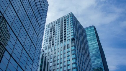 A timelapse of clowd at the building in the business town wide shot panning