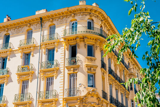 Traditional French old building with typical balconies and windows. Nice, France. High quality photo
