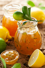 Homemade Lemon and Lime Marmalade in jar with fresh fruits.