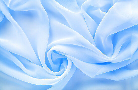 light blue transparent fabric draped with large folds