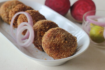 Air fried beetroot cutlets. Served with onions.