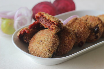Air fried beetroot cutlets. Served with onions.