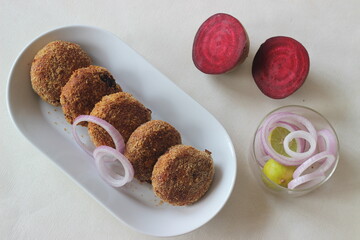 Air fried beetroot cutlets. Served with onions.