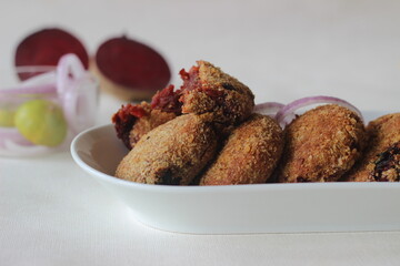 Air fried beetroot cutlets. Served with onions.