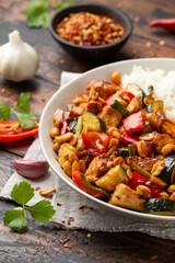Kung Pao Chicken with Peppers, zucchini and rice. Asian take away food