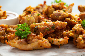 Chicken Pakora dish with sweet chilli sauce on white wooden board