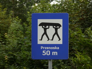 Canoe portage sign with with inscription "Portage 50m ahead" (In Polish "Przenoska 50 m"), Radunia river, Pomorskie province, Poland