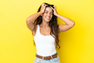 Young caucasian woman isolated on yellow background laughing