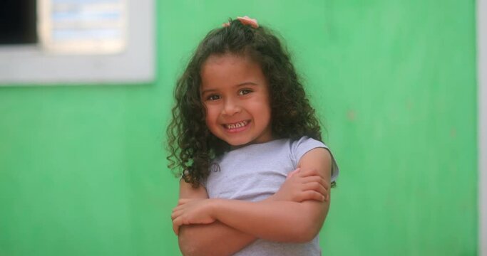 Cute shy little Brazilian girl. hispanic south american kid giving positive thumb up