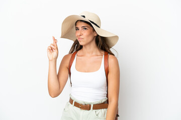 Young caucasian woman wearing a Pamela in summer holidays isolated on white background with fingers...
