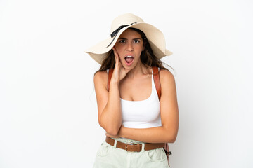 Fototapeta premium Young caucasian woman wearing a Pamela in summer holidays isolated on white background surprised and shocked while looking right
