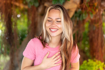 Fototapeta premium Young pretty blonde girl at outdoors smiling a lot