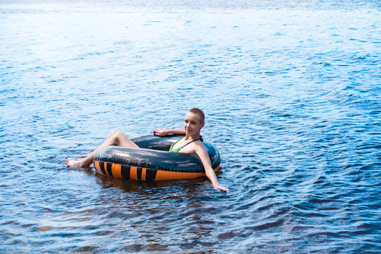 Teen Girl Swimming Using A Swim Tube