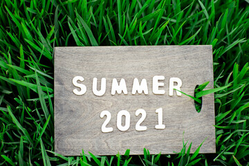 wooden background, with the word summer made of small wooden letters
