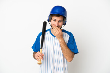 Young caucasian man playing baseball isolated on white background happy and smiling covering mouth with hand