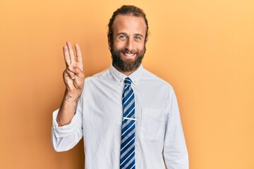 Handsome man with beard and long hair wearing business clothes showing and pointing up with fingers number three while smiling confident and happy.