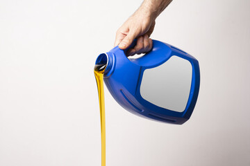 Male hand pouring detergent liquid from a blue bottle with blank label - editable mockup template