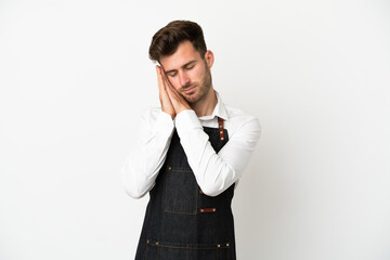 Restaurant caucasian waiter isolated on white background making sleep gesture in dorable expression