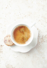 Cup of Coffee on bright stone background. Top view. Close up.	