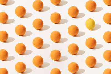 Orange and yellow lemon on a light background. Minimal summer and winter scene with vitamins. Pattern.