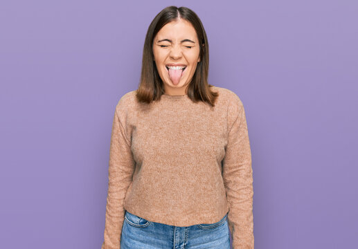 Young beautiful woman wearing casual clothes sticking tongue out happy with funny expression. emotion concept.