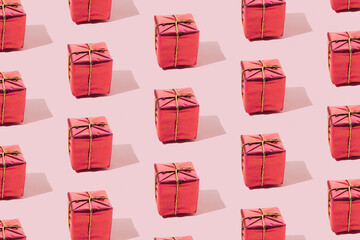 Red gift box on a pink background. Minimum pattern.
