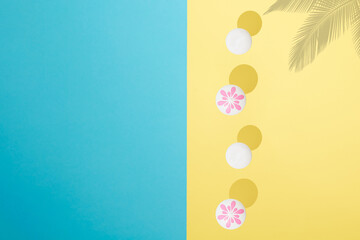 Summer scene. Sea umbrellas on a yellow and blue background with the shade of a palm tree.