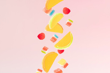 Colorful jelly falling sweets. Pink background. Minimal design.