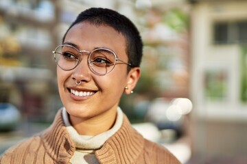 Beautiful hispanic woman with short hair smiling happy outdoors