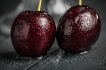 Fresh juicy cherries. Red cherry on a dark background. Macro photo.