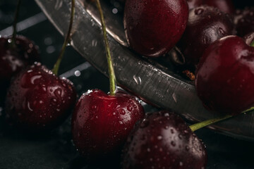 Fresh juicy cherries. Red cherry on a dark background. Macro photo.