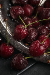 Fresh juicy cherries. Red cherry on a dark background. Macro photo.