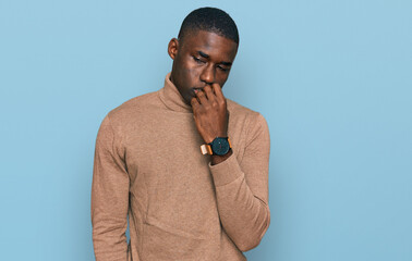 Young african american man wearing casual winter sweater looking stressed and nervous with hands on...