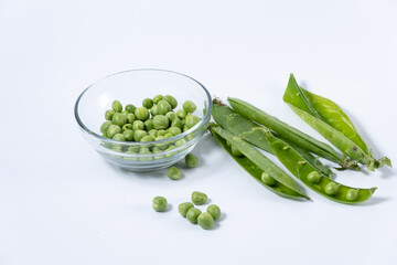 Bowl with fresh peas taken from their pods