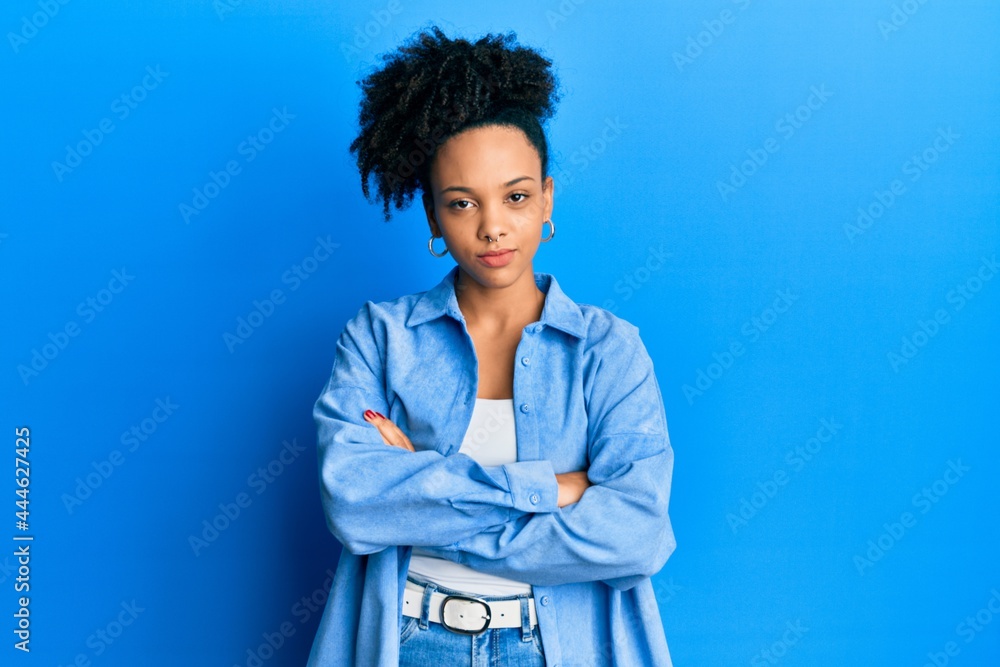 Canvas Prints Young african american girl wearing casual clothes skeptic and nervous, disapproving expression on face with crossed arms. negative person.