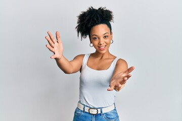 Young african american girl wearing casual style with sleeveless shirt looking at the camera...
