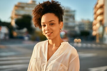 Young african american businesswoman smiling happy standing at the city.