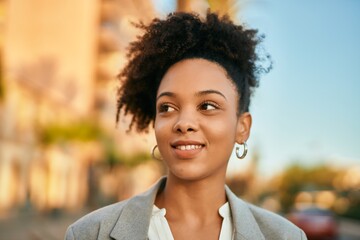 Young african american businesswoman smiling happy standing at the city.