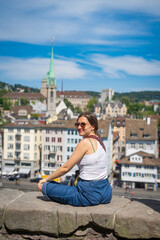 beautiful girl travelling in Zurich taking photo with landscape in Zurich, Switzerland - obrazy, fototapety, plakaty