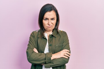 Middle age hispanic woman wearing casual clothes skeptic and nervous, disapproving expression on...