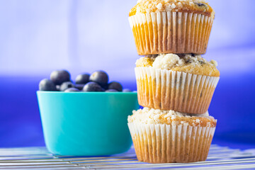 Stacked Blueberry Muffins Against a Blue Background