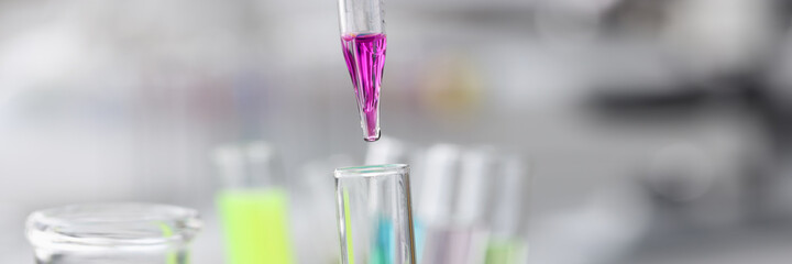 Purple liquid is dropped from pipette into test tube