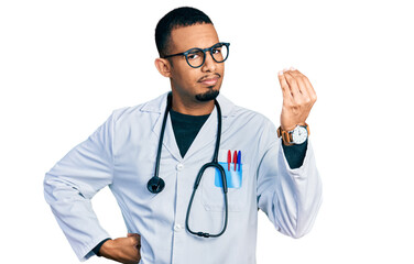 Fototapeta premium Young african american man wearing doctor uniform and stethoscope doing italian gesture with hand and fingers confident expression