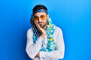 Young hispanic businessman wearing party funny style with tie on head thinking looking tired and bored with depression problems with crossed arms.