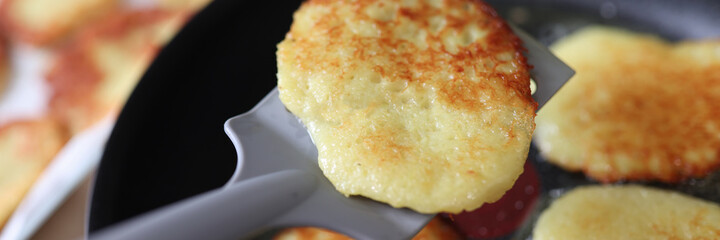 Fried potato pancakes in pan. Cooking at home