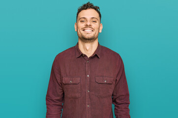 Obraz premium Young hispanic man wearing casual clothes with a happy and cool smile on face. lucky person.