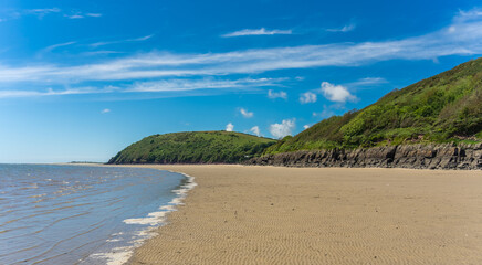 View of LLansteffan beach in southern Wales surrounded by sand and small hills