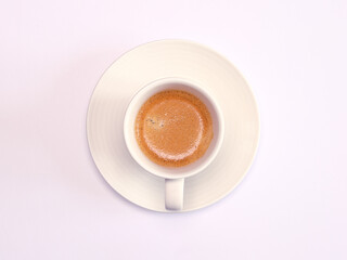 Closeup of a cup of cappuccino on the white background. Top view.