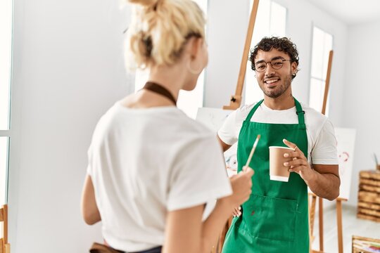 Young artist couple smiling happy standing at art studio.